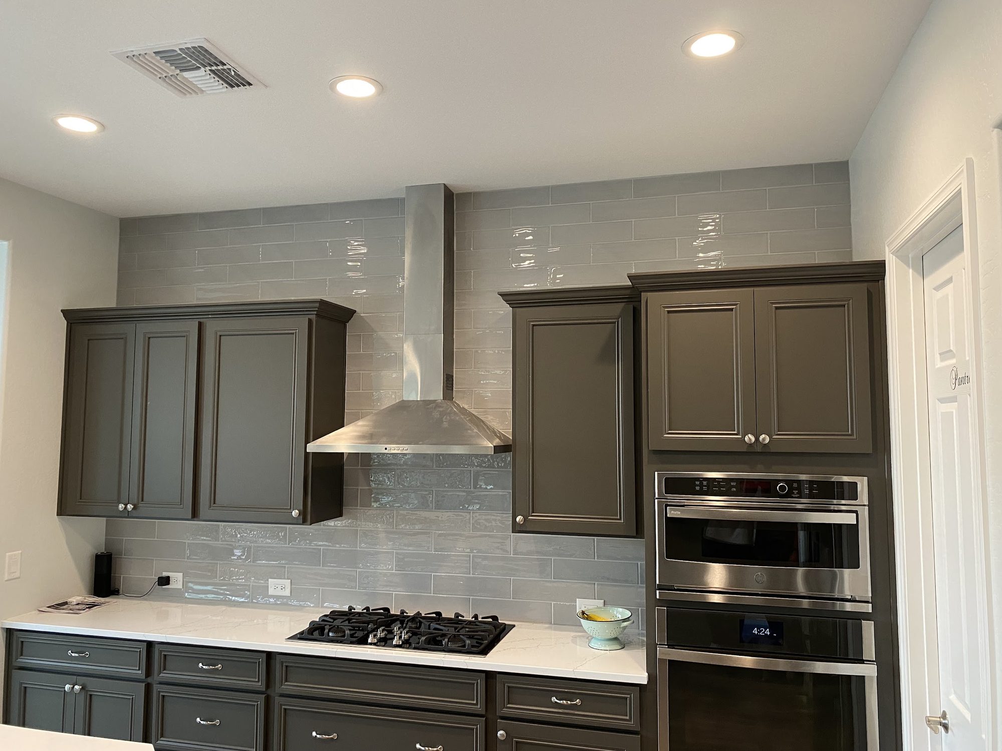 Kitchen with a full height tile wall by JCP Tile & Stone